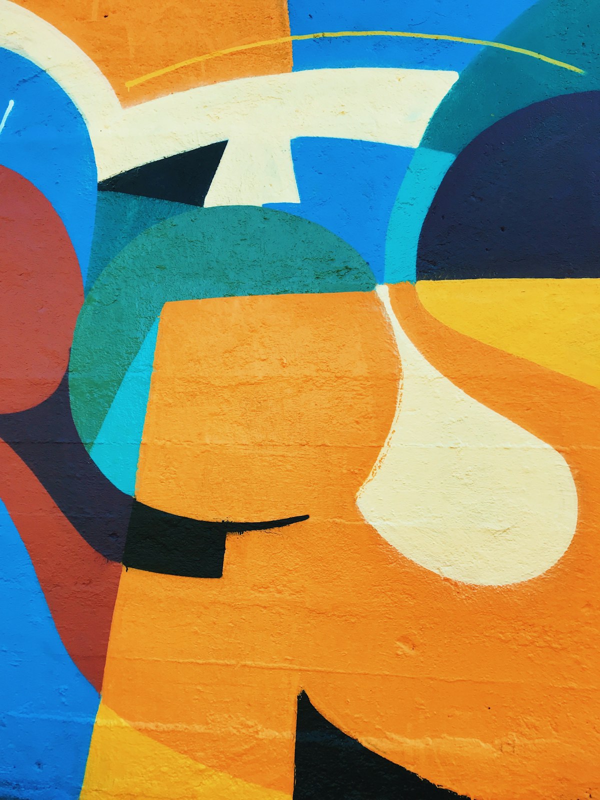A bold graphic mural in orange and blue.