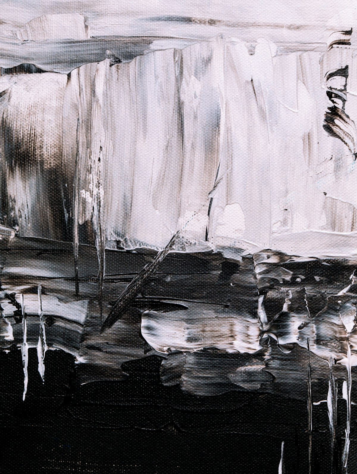 A textured black and white abstract painting.